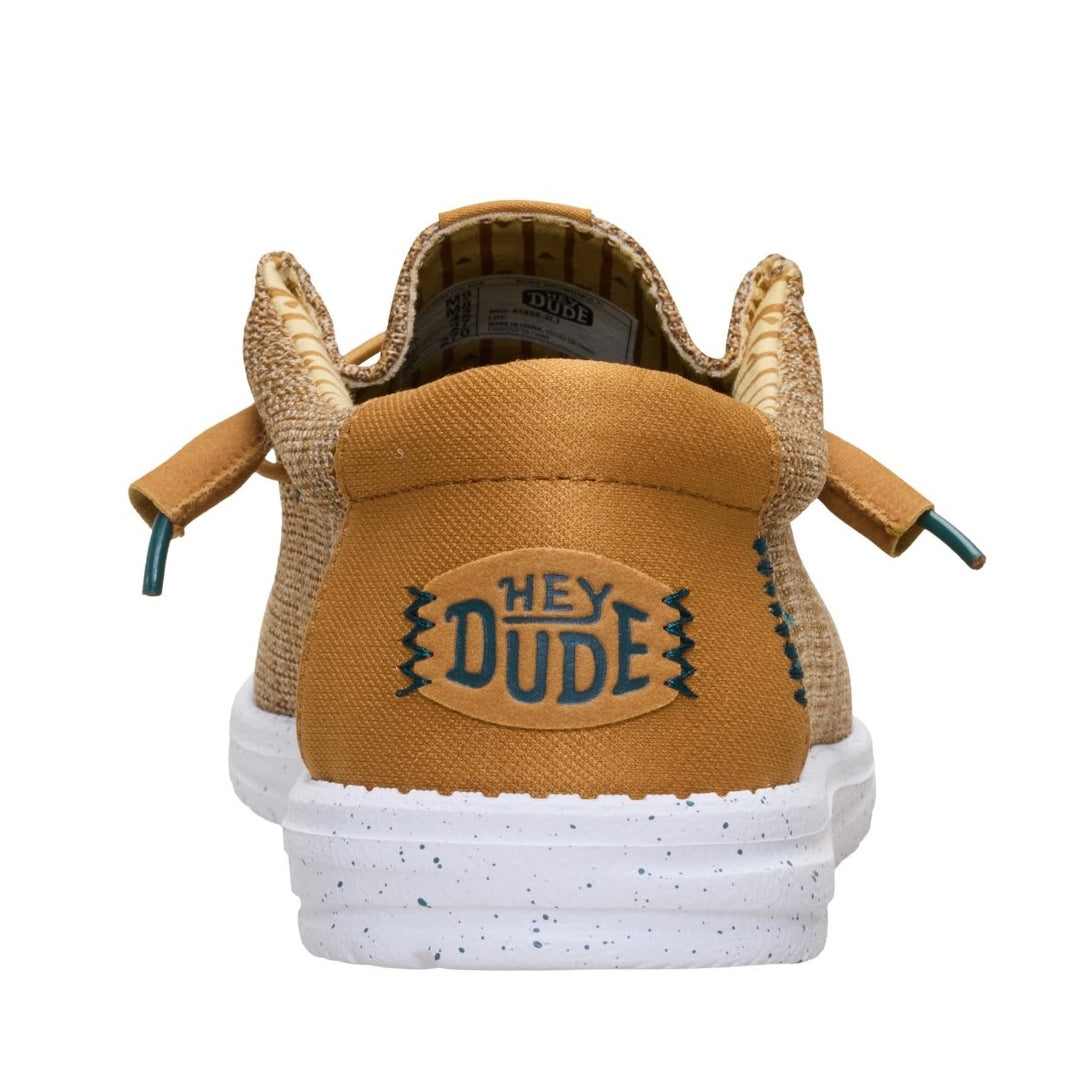Back heel view of a men's Dude Wally Stretch Sox lightweight mesh shoe in Bone Brown / Multi, with elastic laces, a white speckled sole and plain tan brown back panel with Hey Dude logo.