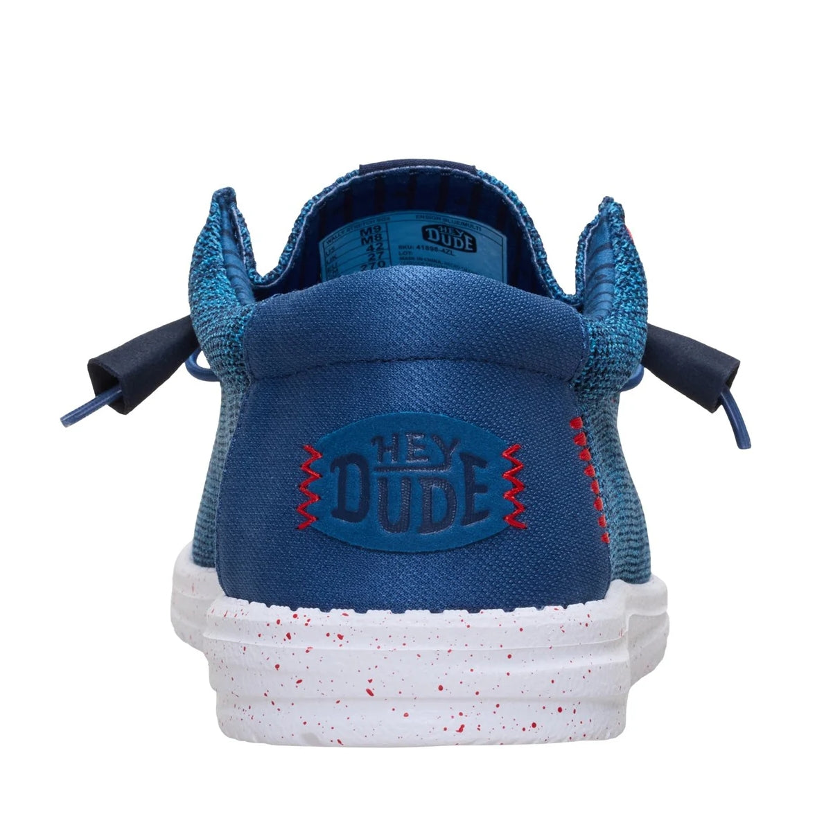 Back heel view of a men's Dude Wally Stretch Sox lightweight mesh shoe in Ensign Blue / Multi, with elastic laces, a white speckled sole and plain blue back panel with Hey Dude logo.