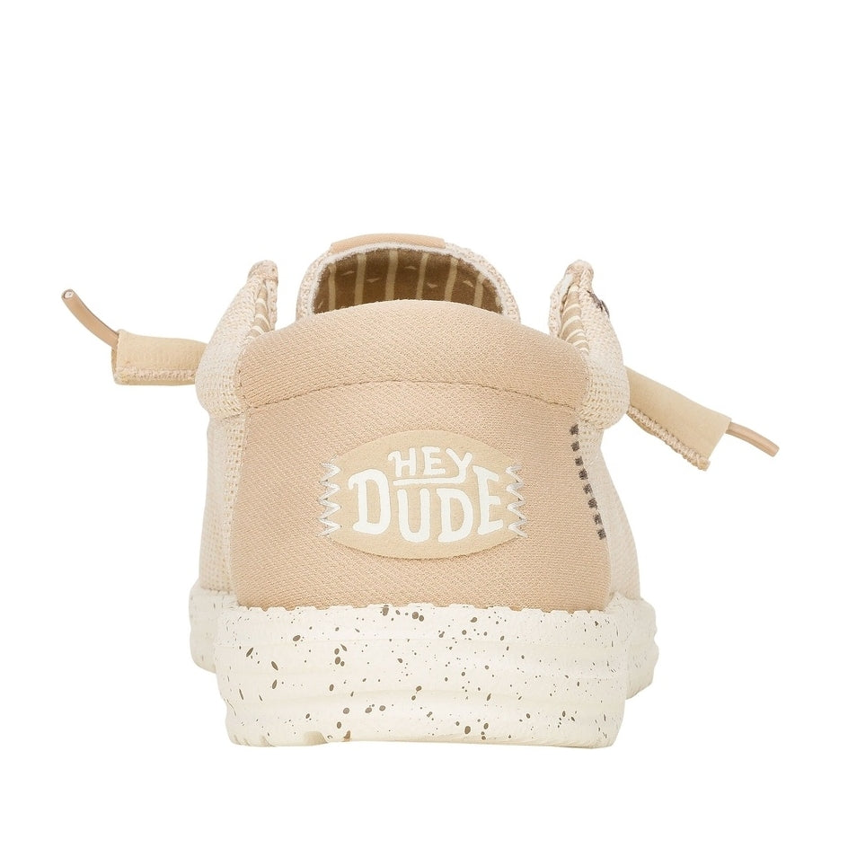 Back heel view of a men's Dude Wally Stretch Sox lightweight mesh shoe in Irish Cream / Egret, with elastic laces, a white speckled sole and a back panel with Hey Dude logo.