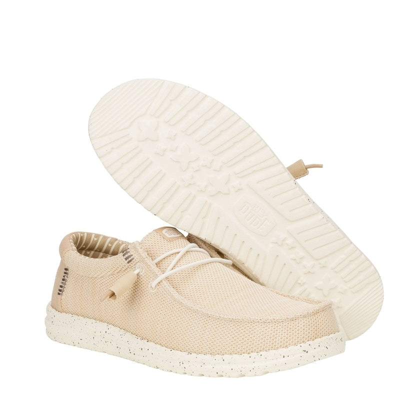 A pair of men's Dude Wally Stretch Sox lightweight mesh shoes in Irish Cream / Egret, with elastic laces and showing the bottom white outsole.
