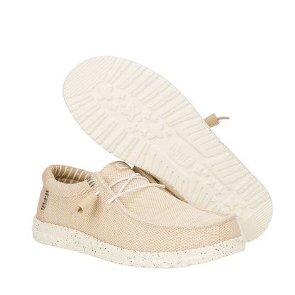 A pair of men's Dude Wally Stretch Sox lightweight mesh shoes in Irish Cream / Egret, with elastic laces and showing the bottom white outsole.