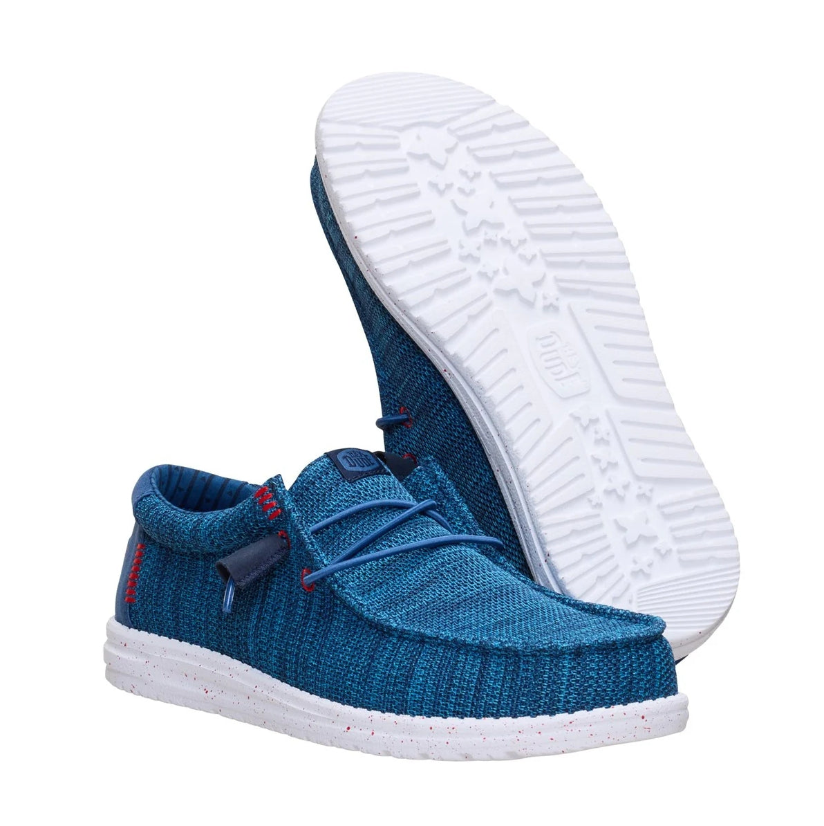 A pair of men's Dude Wally Stretch Sox lightweight mesh shoes in Ensign Blue / Multi, with elastic laces and showing the bottom white outsole.