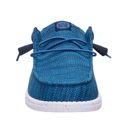 Front toe view of a men's Dude Wally Stretch Sox mesh shoe in Ensign Blue with elastic laces, white speckled sole and Hey Dude logo patch on the tongue.