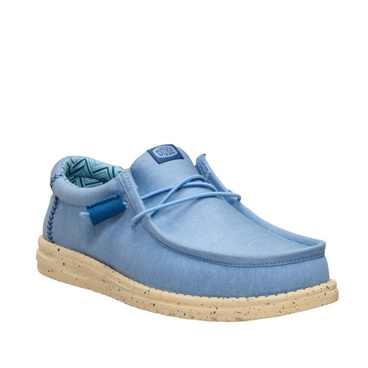 Main front view of a men's Dude Wally Stretch Canvas lightweight shoe in Faded Denim Blue / Boulder Tan, with elastic laces and a speckled sole.