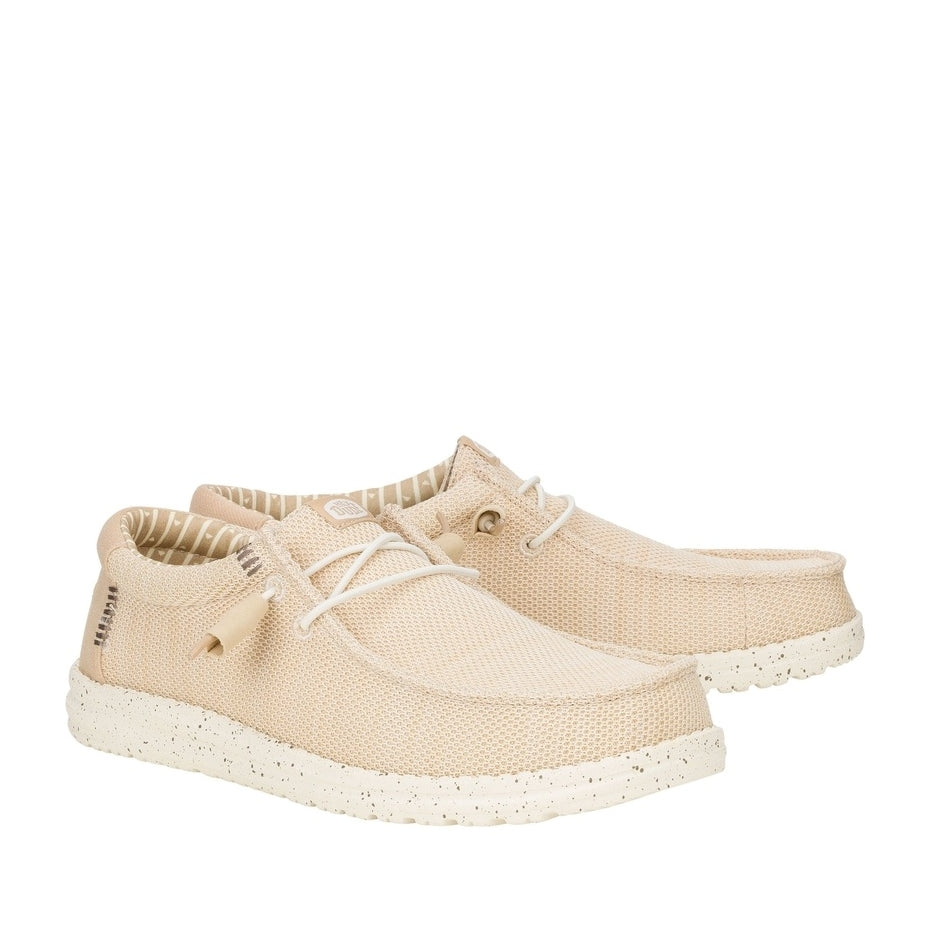 A pair of men's Dude Wally Stretch Sox shoes in Irish Cream / Egret with white speckled soles, elastic laces and brown stitching accents.