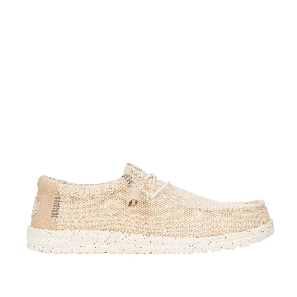 Side view of a men's Dude Wally Stretch Sox lightweight mesh shoe in Irish Cream / Egret, with elastic laces a speckled sole and brown stitching accents.
