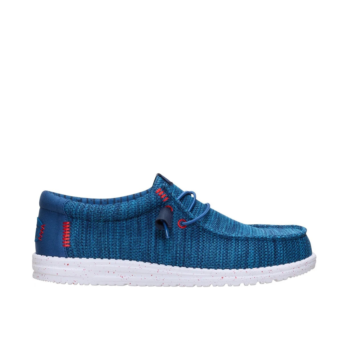 Side view of a men's Dude Wally Stretch Sox lightweight mesh shoe in Ensign Blue / Multi, with elastic laces a white speckled sole and red stitching accents.