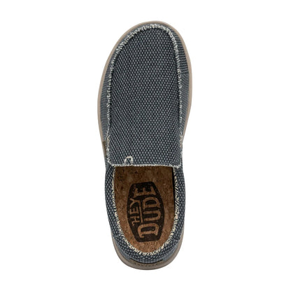 Top view of a men's Dude Mikka Braided lightweight slip on canvas shoe in Deep Blue with cork effect footbed and Hey Dude logo.