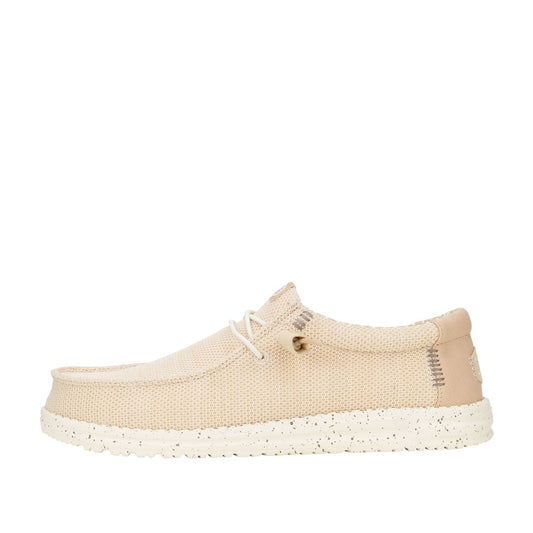 Side view of a men's Dude Wally Stretch Sox lightweight mesh shoe in Irish Cream / Egret, with elastic laces and a speckled sole.