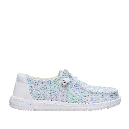Side view of a women's Dude Wendy Stretch Speckle shoe, featuring a white base with a multicolour speckle pattern of blue, green, and pink, with a solid white sole, heel and white laces.