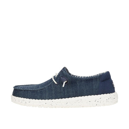 A womens Dude Wendy Stretch Sox slip-on knit shoe in navy blue with a white speckled sole and white laces, shown from a side profile.