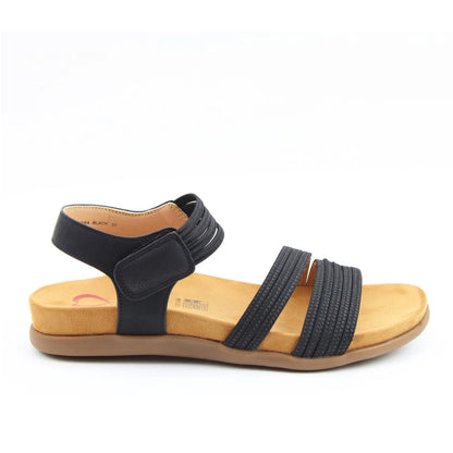 Side view of a women's Heavenly Feet Tyra sandal in black with two front straps, adjustable ankle strap and a tan coloured sole.