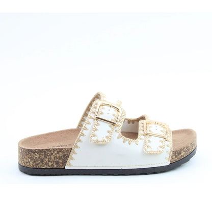 Side view of a women's Heavenly Feet Sandy double buckle slider sandal in Beige with embroidered straps.