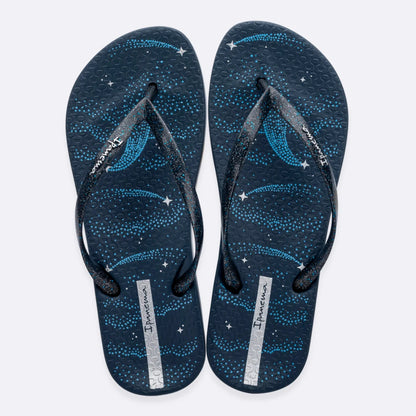 Top view of a pair of women's Ipanema Anatomic Magic Fem flip flops in navy blue / silver, featuring a shooting star print footbed, glittery strap and textured footbed.