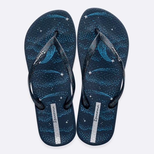 Top view of a pair of women's Ipanema Anatomic Magic Fem flip flops in navy blue / silver, featuring a shooting star print footbed, glittery strap and textured footbed.