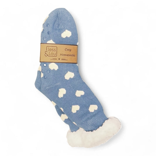 Main front view of a pair of womens Jess & Lou slipper socks in blue with a white heart pattern and a cosy fluffy white lining.