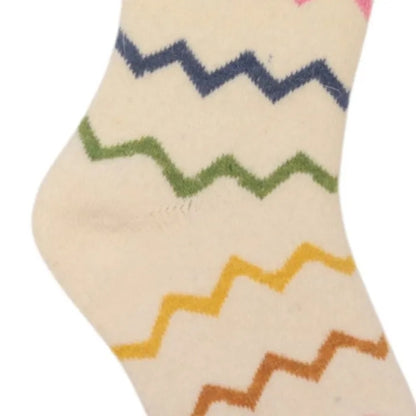Close-up view of a womena Jess & Lou cosy wool blend socks in cream with a multicolour zig-zag pattern.