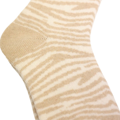 Close-up view of a pair of womens Jess & Lou cosy wool blend socks in an oatmeal and white zebra print.