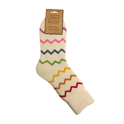Main top view of a pair of womena Jess & Lou cosy wool blend socks in cream with a multicolour zig-zag pattern.