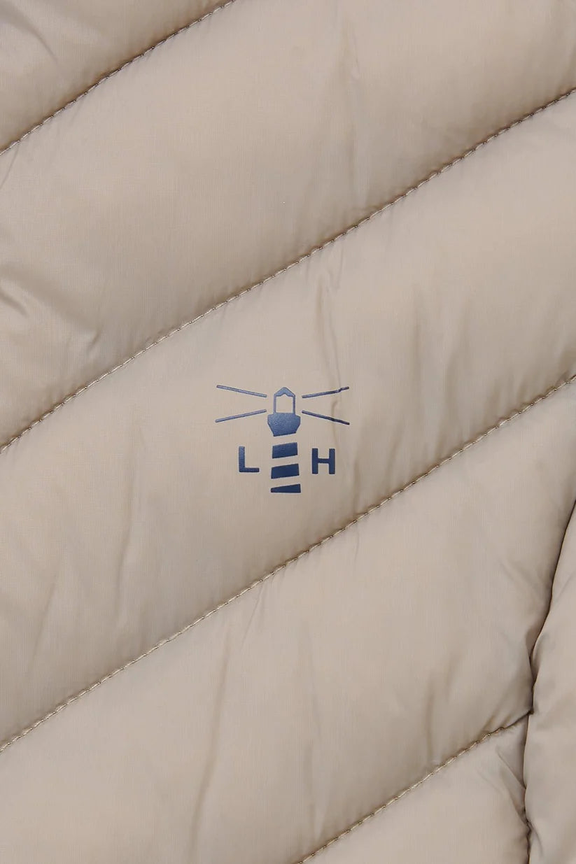 close up of lighthouse logo in navy on mocha gilet  