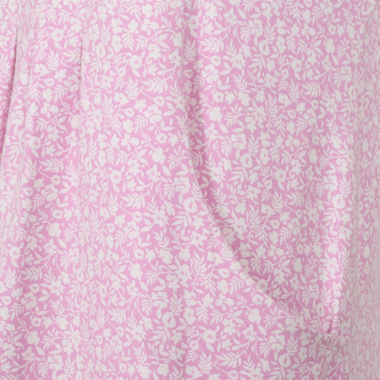 Close-up view a side pocket of a womens Lazy Jacks short sleeve LJ116 tunic in pink with a white ditsy floral pattern