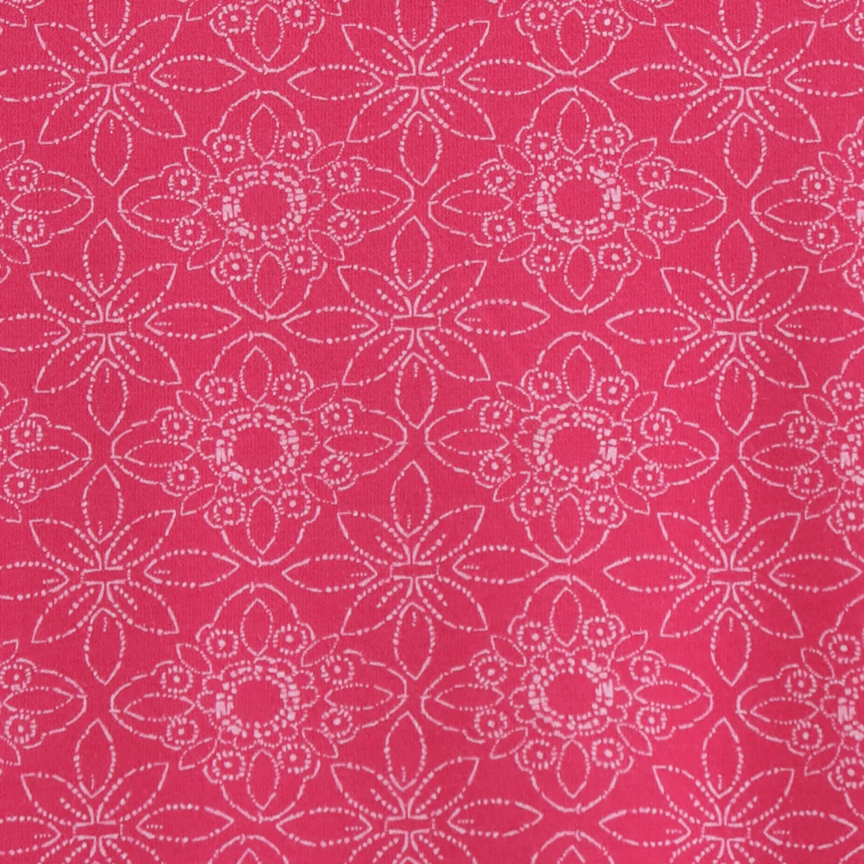 Close-up view of the geometric pattern of a womens Lazy Jacks short sleeve LJ118 tunic in dark pink.