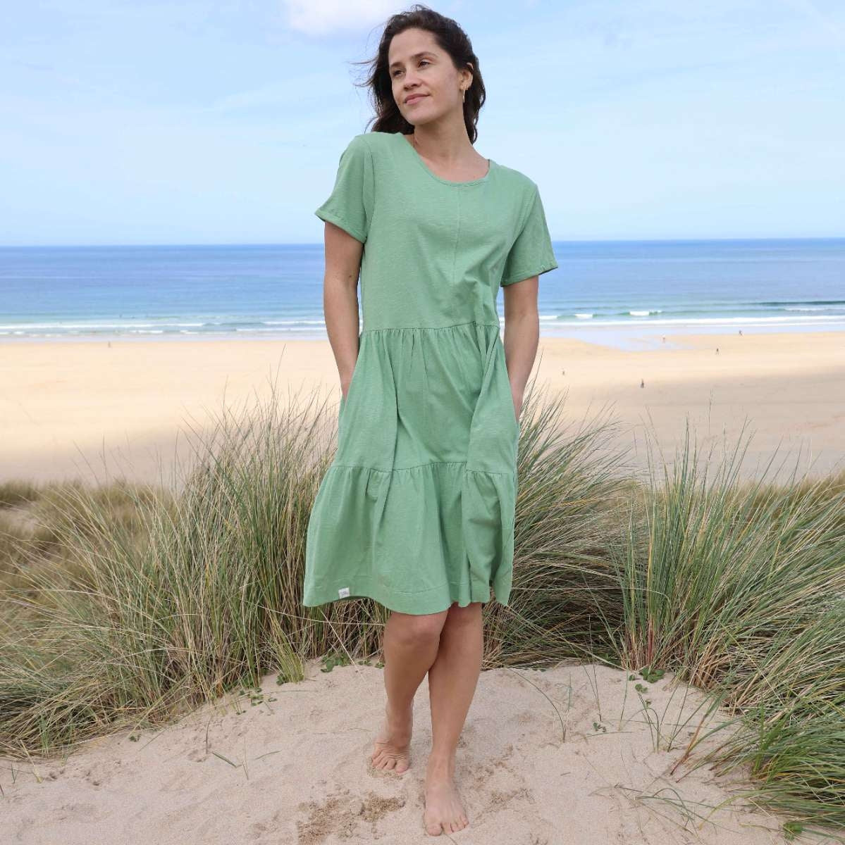 Woman wearing a Lazy Jacks LJ524 short sleeve tiered dress in grass green.