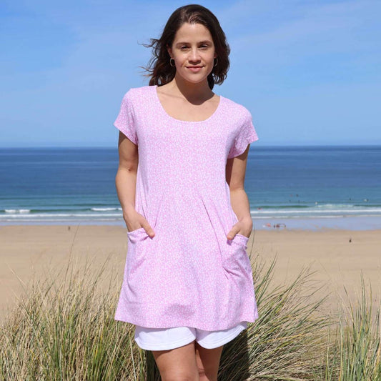 Front view of a woman wearing a Lazy Jacks short sleeve LJ116 tunic in pink with a white ditsy floral pattern