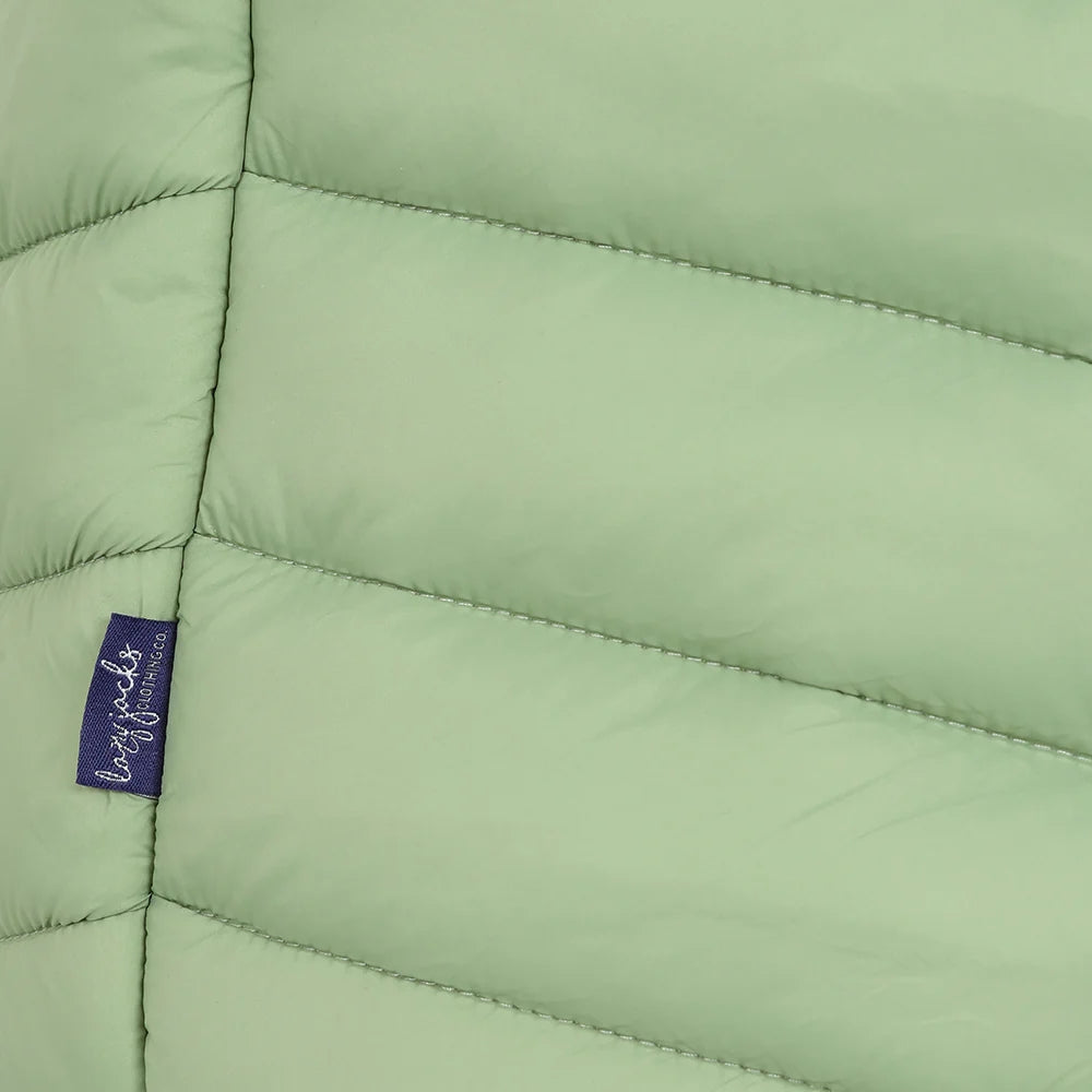Close-up view of a side seam logo label of a womens Lazy Jacks GL2 lightweight padded gilet in Grass Green.