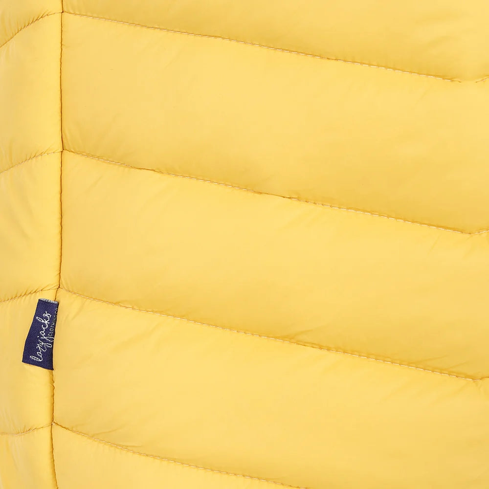 Close-up view of a side seam logo label of a womens Lazy Jacks GL2 lightweight padded gilet in Lemon Yellow.