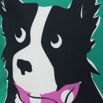Close-up of Lazy Jacks green sheep dog bag featuring a black and white dog illustration on green background
