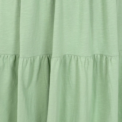 Close-up view of the tiered fabric of a Lazy Jacks LJ524 short sleeve dress in grass green.