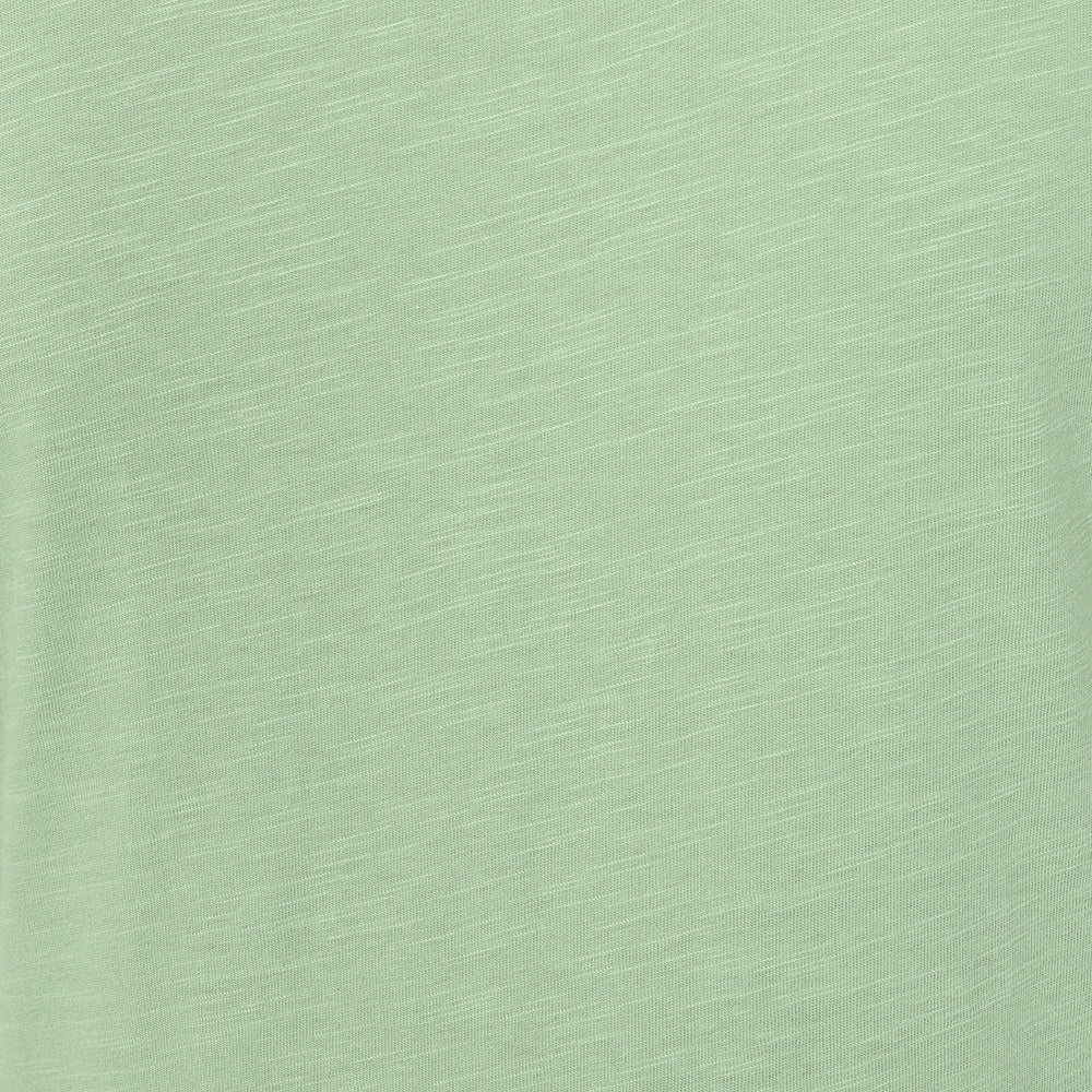 Close-up view of the slub fabric texture of a Lazy Jacks LJ524 short sleeve dress in grass green.