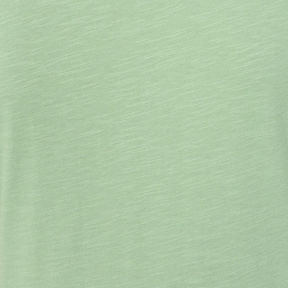 Close-up view of the slub fabric texture of a Lazy Jacks LJ524 short sleeve dress in grass green.