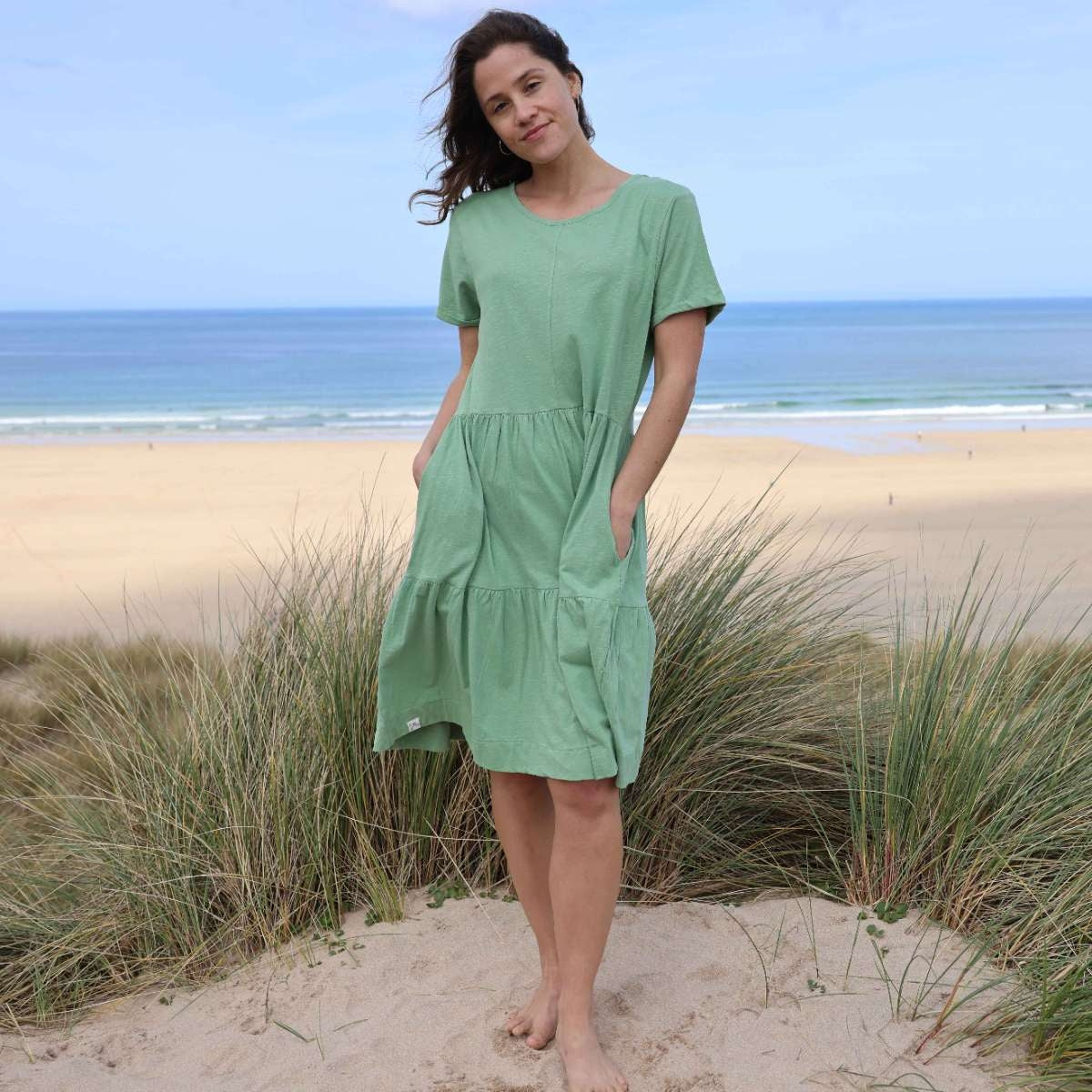 Front view of a woman wearing a Lazy Jacks LJ524 short sleeve tiered dress in grass green.
