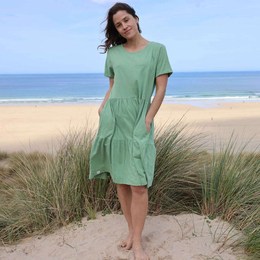 Front view of a woman wearing a Lazy Jacks LJ524 short sleeve tiered dress in grass green.