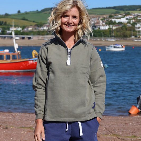 Lazy Jacks womens sweatshirt khaki worn by woman standing near water with boats in background