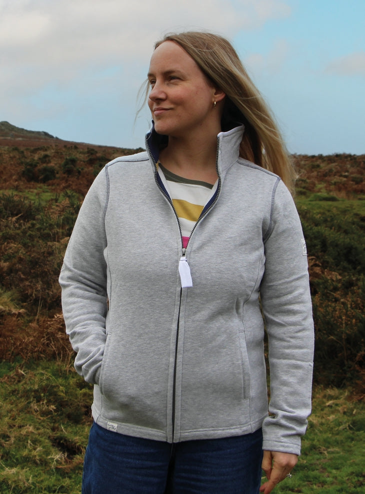 Lazy Jacks womens zip sweatshirt grey worn by woman outdoors with hands in pockets