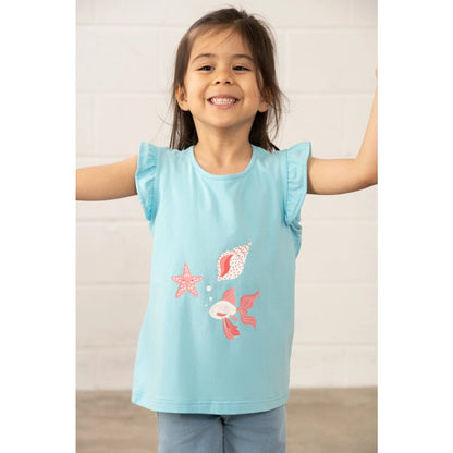 Child wearing a Lighthouse light blue t-shirt with fish, starfish and shell print on a plain background