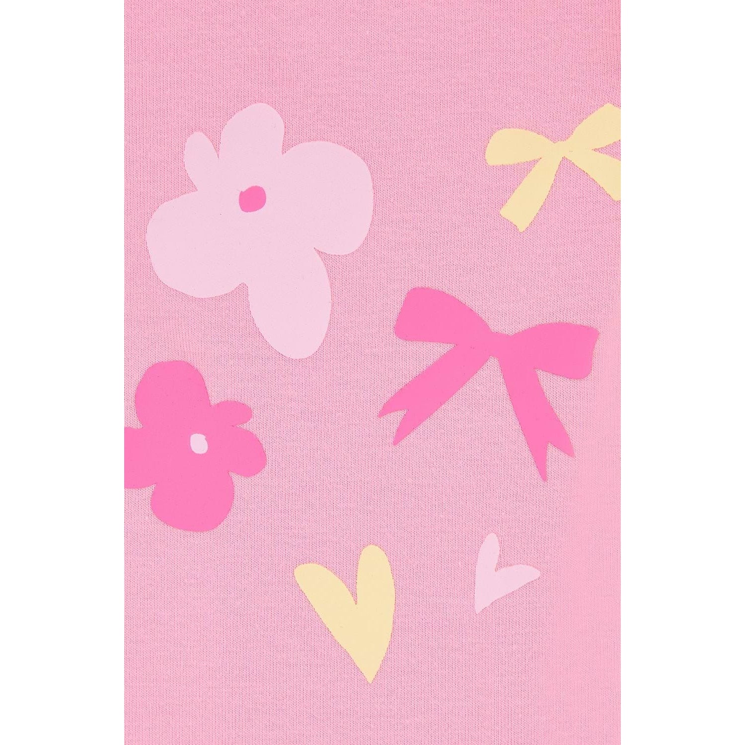 Close-up view of a pair of Lighthouse kids Mollie leggings in Fluro Pink with a bow, heart and flower print on one leg.