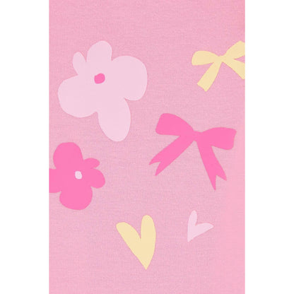 Close-up view of a pair of Lighthouse kids Mollie leggings in Fluro Pink with a bow, heart and flower print on one leg.