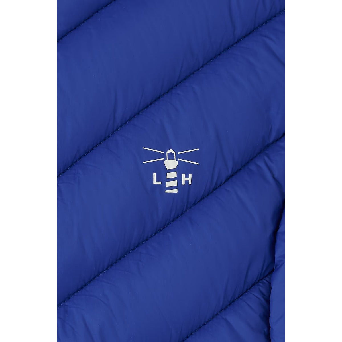 Close-up view of a the padded fabric and printed logo on a Lighthouse padded Laurel Gilet in Indigo Blue.
