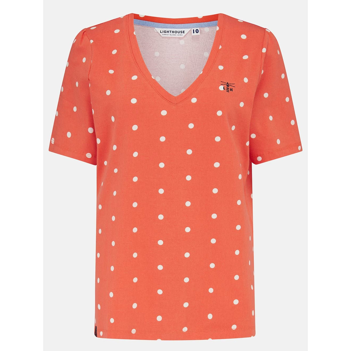 Front view of a womens Lighthouse short sleeve Ariana v-neck t-shirt in coral with a white dot pattern.