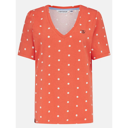 Front view of a womens Lighthouse short sleeve Ariana v-neck t-shirt in coral with a white dot pattern.