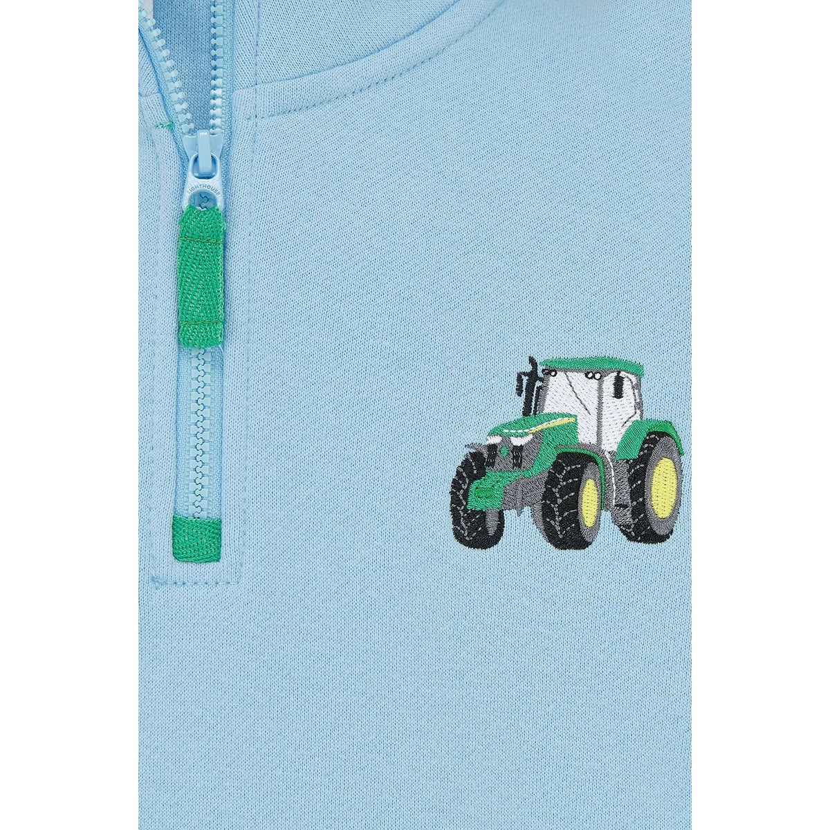 Close-up view of a Lighthouse Jonah zip neck sweatshirt in sky blue with green trim and tractor applique on the chest.