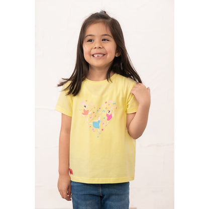 Front view of a girl wearing a kids Lighthouse short sleeve Causeway t-shirt in lemon yellow, featuring a heart shape ballerina print on the front.