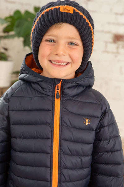 Lighthouse kids navy Carter padded coat with orange zipper and hood worn by smiling child