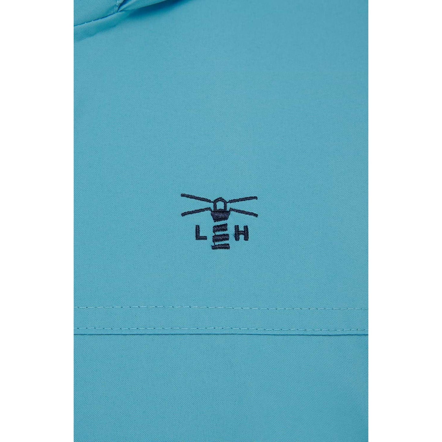 Close-up view of the embroidered logo and fabric of a womens Beachcomber II waterproof jacket in Blue.