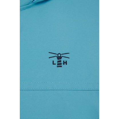 Close-up view of the embroidered logo and fabric of a womens Beachcomber II waterproof jacket in Blue.