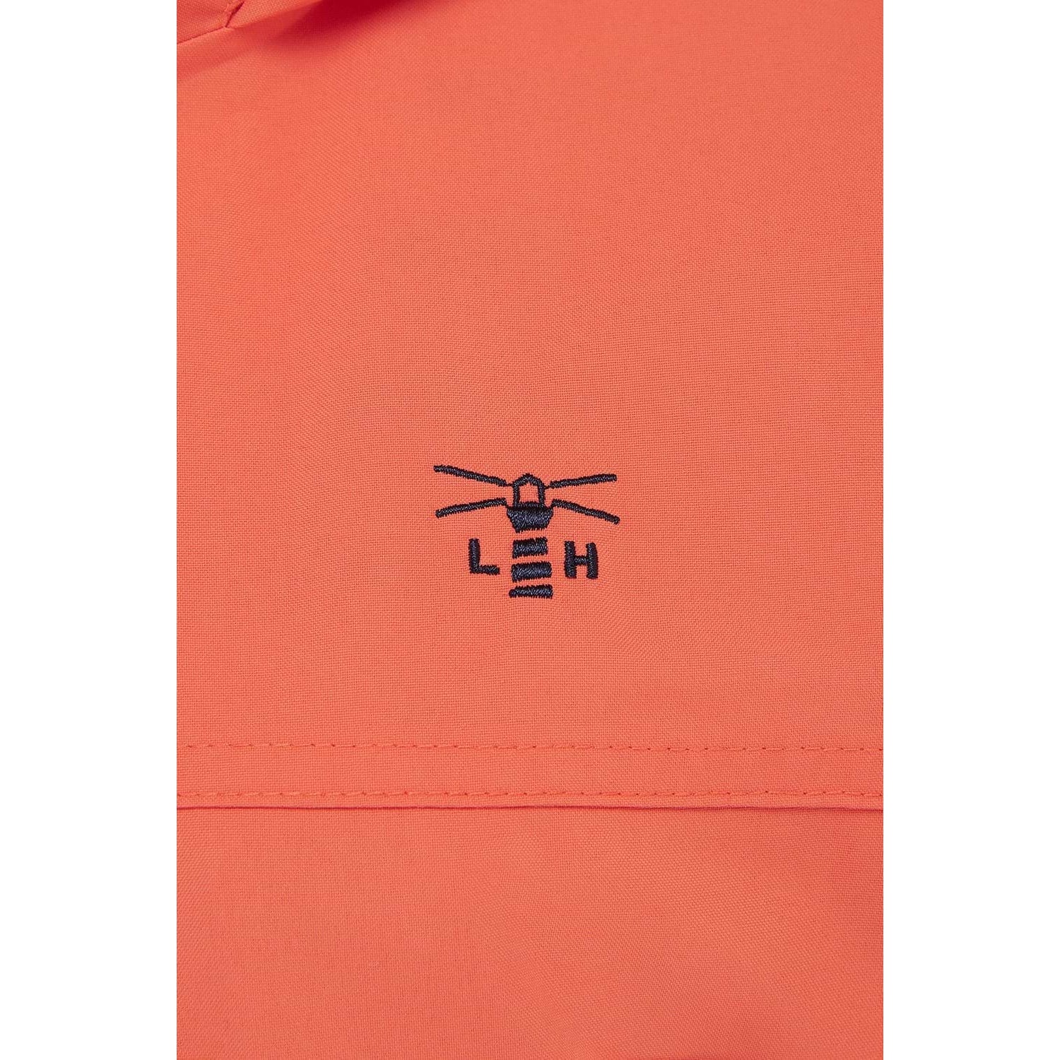 Close-up view of the embroidered logo and fabric of a womens Beachcomber II waterproof jacket in Coral.